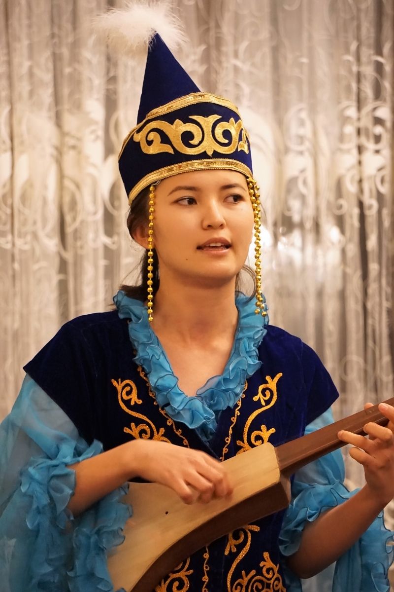 Femme kirghize jouant du komuz, instrument traditionnel kirghize